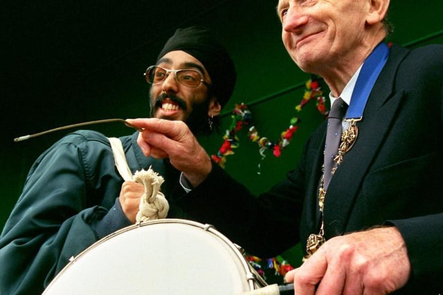 Jotinder Singh teaches the Mayor of Preston, Coun Geoff Swarbrick to play the drums