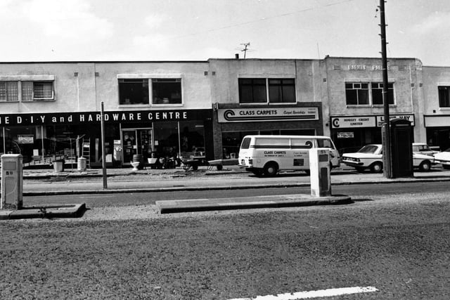Parade of shops on Dewsbury Road in July 1980. On the left is a double fronted D.I.Y and hardware centre. Next is Class Carpets. Moving right a credit lending service, then a washeteria laundrette.