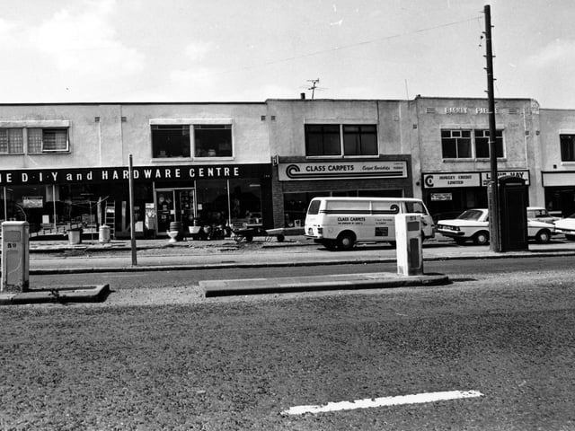 Parade of shops on Dewsbury Road in July 1980. On the left is a double fronted D.I.Y and hardware centre. Next is Class Carpets. Moving right a credit lending service, then a washeteria laundrette.