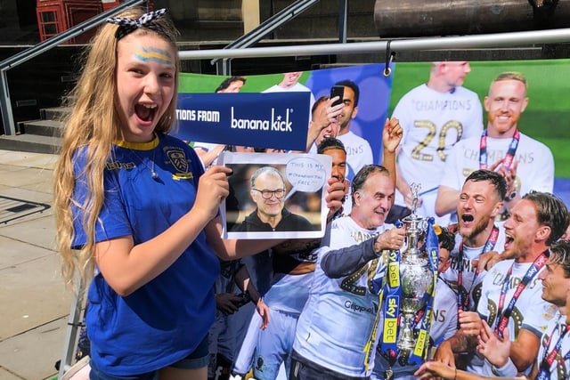 A fan poses with a photograph of Marcelo Bielsa