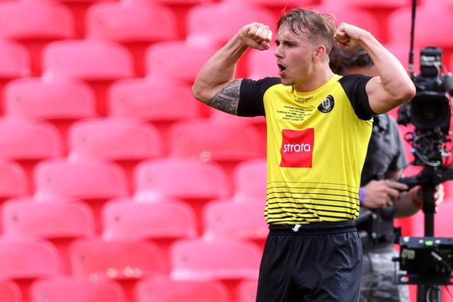 Loan star Jack Diamond is the hero as he celebrates Harrogate Town's third goal of the day and the one which clinches promotion to the Football League.