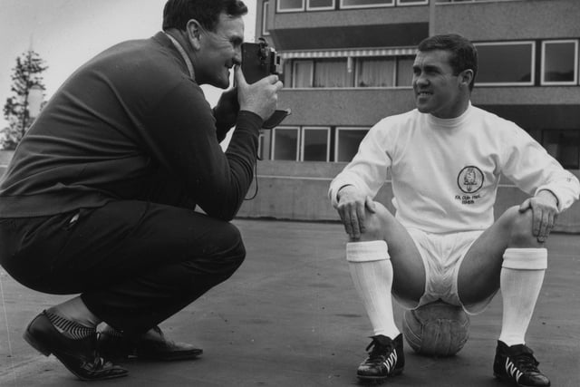 Leeds United manager Don Revie snaps a picture of Bobby Collins.