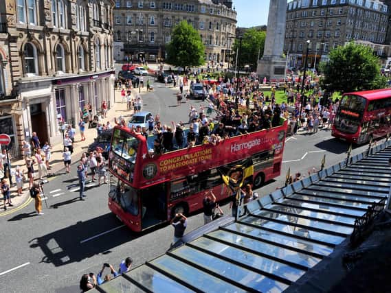 Harrogate Town touring the streets on an open-top bus.