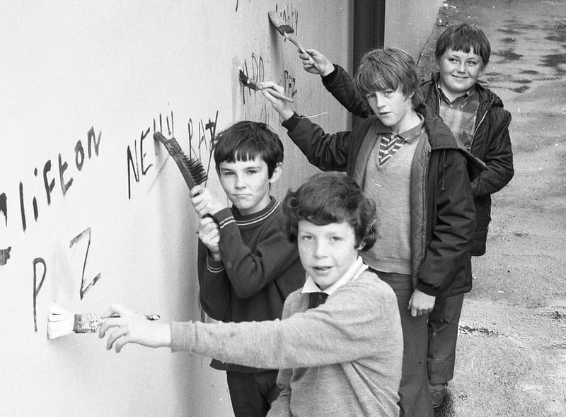 Robert Halshaw, 10;  Liam Donnelly, 12; Austin Taylor, 11; and Anthony Corrigan, 11 - all members of the "St Augustine's Youth Club Tidy Club" clean a wall in Manchester Road, Preston