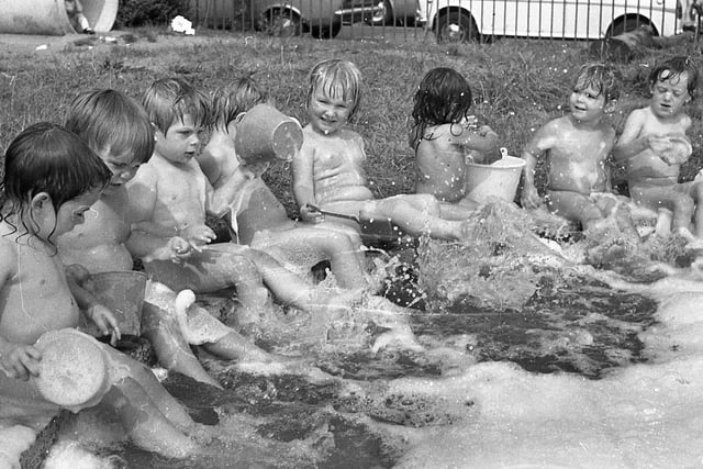 Bath time was never like this... and what a sneaky way these grown-ups have of keeping us clean! Children of the Hartington Road Day Nursery, Preston, don't know anything about centigrade and fahrenheit but they reckon that clothes are just a waste of time when the sun is beating down and there's a paddling pool outside. But never mind the heatwave...