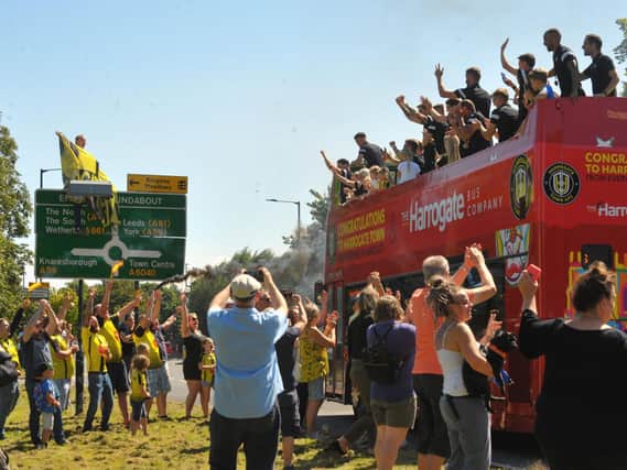 The open-top bus went around the streets of Harrogate showing off Town's trophy.