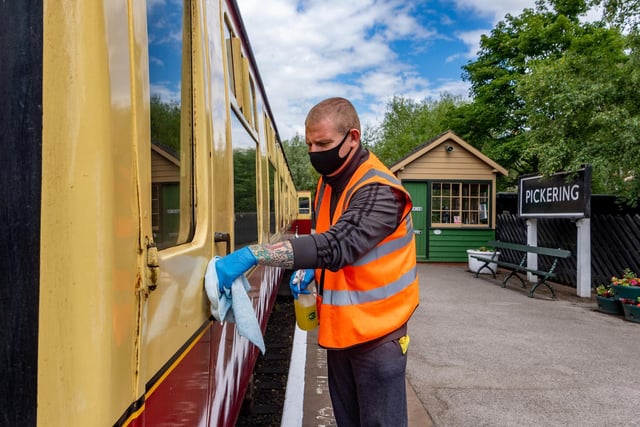 Jamie Suter cleaning the carriage as part of the Covid-19 safety precautions