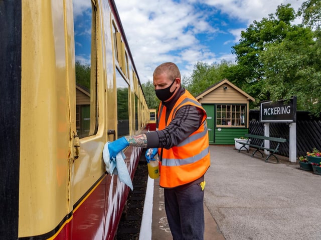 Jamie Suter cleaning the carriage as part of the Covid-19 safety precautions