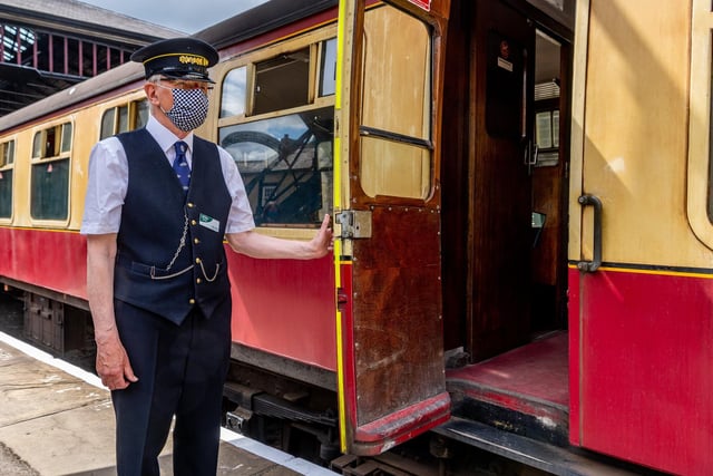 Station Foreman Peter Blake opening the carriage door