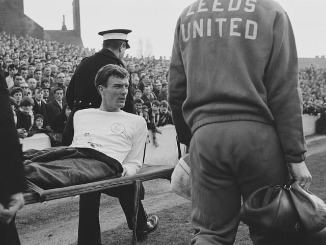 Paul Madeley is carried off after an injury during a League Division One match against Nottingham Forest in February 1966.
