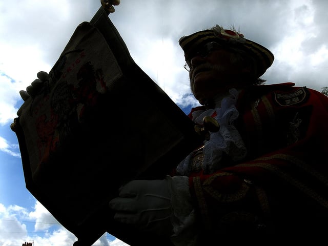 The charter is read by Town Crier Alan Booth as the sun breaks in the sky.