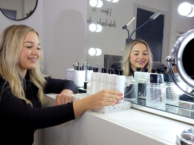 Millie Hunter arranging products