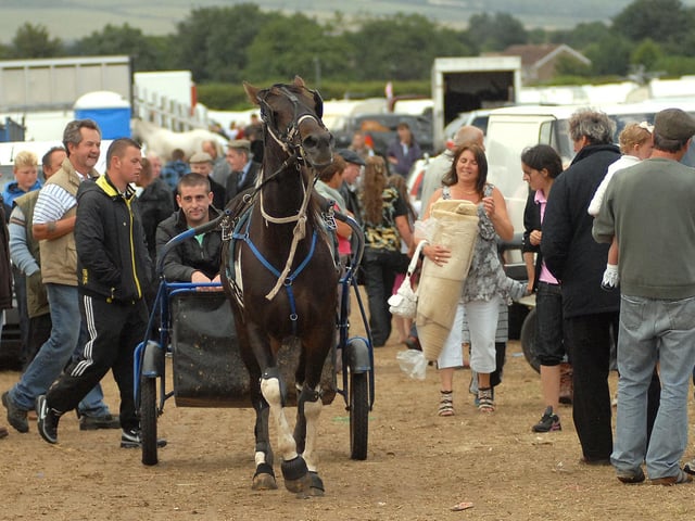 Fair-goers look on as this man enjoys a trot through the site.