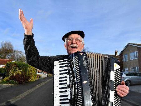 Musician Bryan Young entertaining neighbours in Longton with his violin and accordian to keep their spirits up