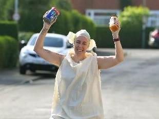 Annette Russ of Red Rose Road runners running in her Dobby costume whilst collecting food for local foodbanks