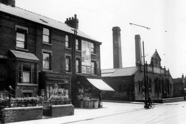 Shops and houses on corner of Compton Road and Hudson Road. Burton's clothing factory on opposite corner. a boy with a bicycle stands at edge of road by two belisha beacons
