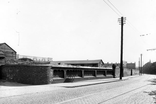 Behind the high brick wall is the sports ground for employees of Montague Burton the tailors.