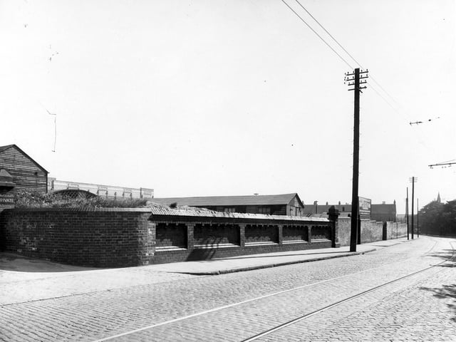 Behind the high brick wall is the sports ground for employees of Montague Burton the tailors.