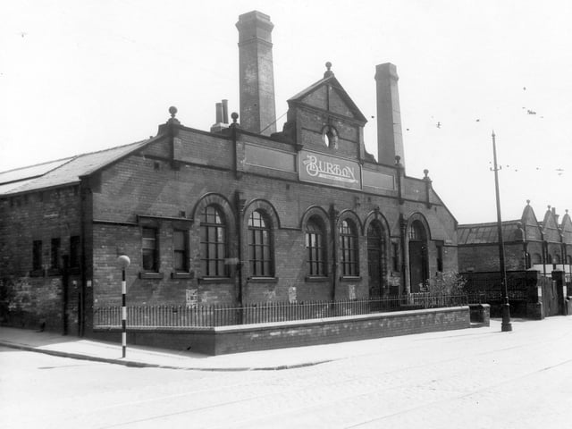 The premises of Montague Burton, The Tailor of Taste, showing building with large arched windows and two chimneys in the background. Pictured in June 1939.