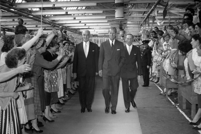 HRH The Duke of Edinburgh is being escorted by Lionel Jacobson, chairman of the company, and his brother Sydney Jacobson, through the factory.