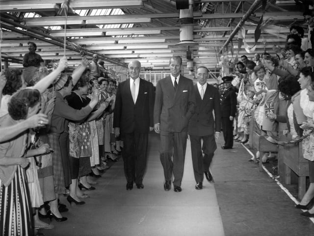 HRH The Duke of Edinburgh is being escorted by Lionel Jacobson, chairman of the company, and his brother Sydney Jacobson, through the factory.