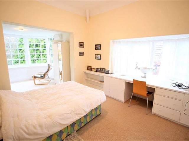 Second bedroom with bay window overlooking grounds.
