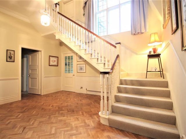 Welcoming entrance hall with doors leading to the living room and conservatory.