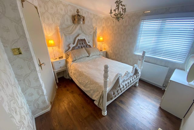 The master bedroom comes complete with a four posted bed adorned with a crown.