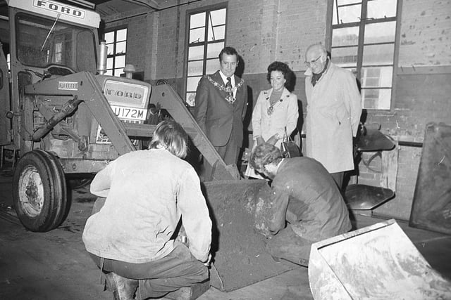Mr Norman Clay, Kirkham Prison governor with the Mayor and Mayoress of Fylde, Coun Bob Joyce and Mrs Marion Joyce, watching men working on some of the machinery in the tractor shed, during their tour of the prison