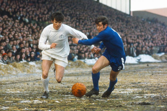 Eddie Gray takes on a defender, opposition unknown, on a snowy Elland Road pitch.