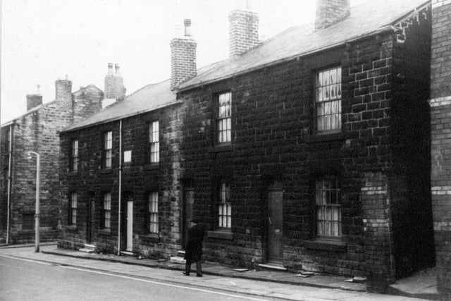 Wesley Street looking towards Cross Street in March 1967. A man walks past the terraced houses.