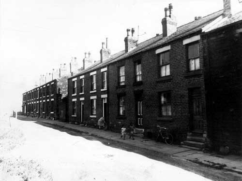 Terraced houses in Cobden Street in 1964. Two children are walking on the pavement.
