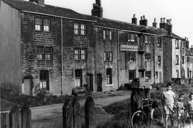 Three storey terraced houses on Hunger Hill in June 1965. In the centre of the photograph are the premises of John Bragg, bagging, rag and waste merchant.