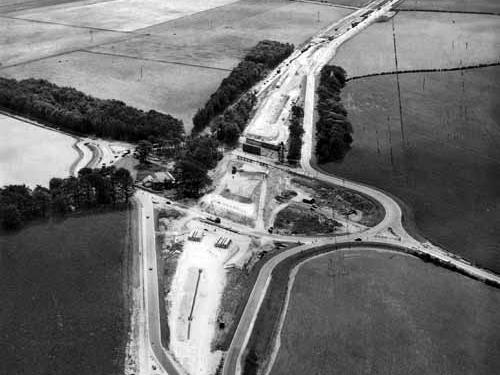A1 junction at Boston Spa, with the A1 flyover under construction. The view is looking south with the A1 (Great North Road) running from top to bottom and the A659 from left to right.