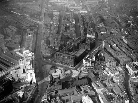 Wellington Street runs vertically on the left and Infirmary Street running diagonally towards the top right. Taken after 1937, when the Queens Hotel, seen on the bottom left, was opened but exact year unknown.