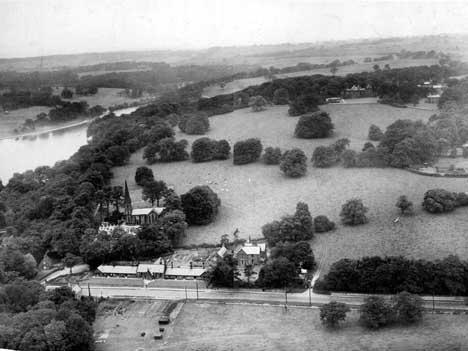 Looking north from Wetherby Road which runs across the bottom of the picture. St. John's Church can be seen, with the school and vicarage in front. Waterloo Lake is on the left. Elmete Hall can be seen in the background on the right.