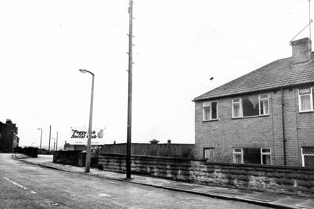 December 1979 and view of the entrance to the Peggy Tub Social Club, formerly Woodhouse Hill Liberal Club, with semi-detached houses on the right.