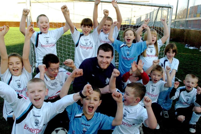 PNE keeper Andy Lonergan is mobbed by junior North Enders at the opening of the new all weather pitch at West View Leisure Centre
