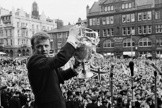 Captain Billy Bremner proudly shows off the trophy.