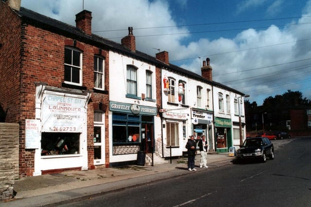 September 2000 and two young men are standing at the curb in front of the fish and chip shop on Chapel Street, Halton.