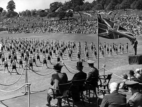 Demonstration and exhibition by the children of Leeds in 1944. A group of boys are performing a gymnastic routine, watched by HRH Duke of Gloucester, with Lord Mayor Albert Hayes and Lady Mayoress Mrs Hayes.