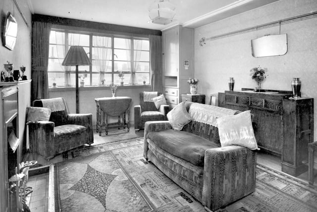 Living room in 1939. Furnished in typical 1930s style, the layout of the room makes the fire the focal point, with comfortable seating arranged near it.