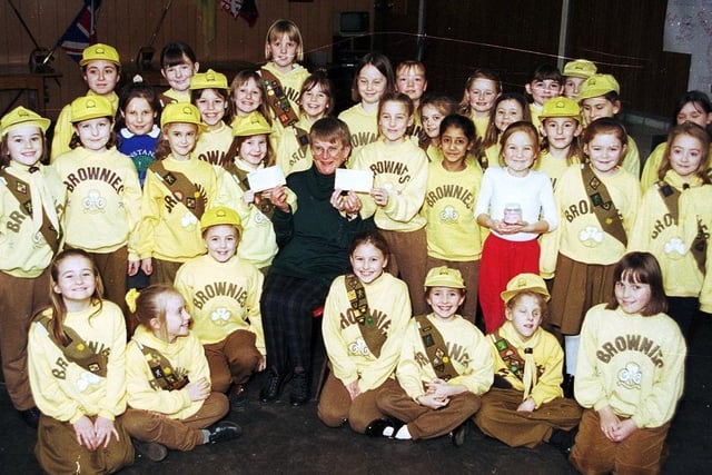 Wigan's caring Brownies pictured handing over cheques to local charities in 1996