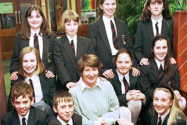 RETRO 1996  - Caring pupils at St Edmund Arrowsmith RC High School handover the proceeds of fundraising to a representative from Derian House children's hospice.