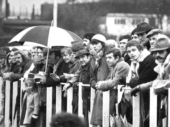 A crowd of rugby fans watch a match at Wigan Rugby Union club, 1974
