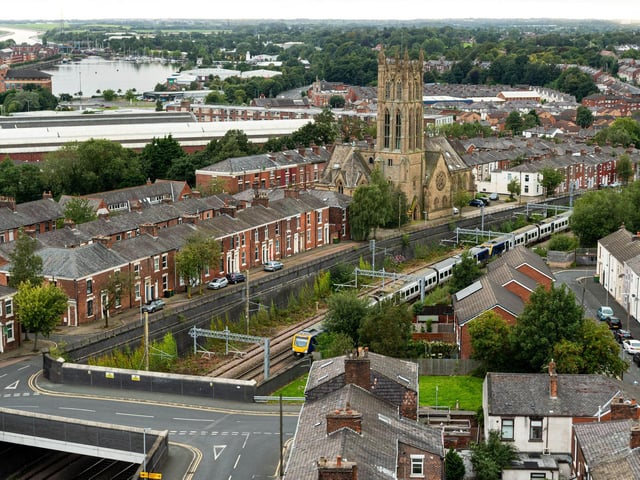 A train passes by St Mark's Church.