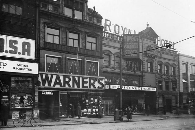 Shops on Briggate, left to right, are Watson Cairns, Direct Woollen Co, Royal Hotel, Lamberts Chambers. Entrance to Bowers Yard. The Whip public house can also be seen.