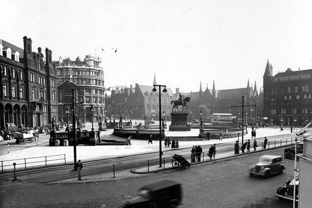 View across City Square from Queen's Hotel, traffic in foregound. Post Office and Standard Life Assurance to left, Mill Hill Chapel and AA building to right.