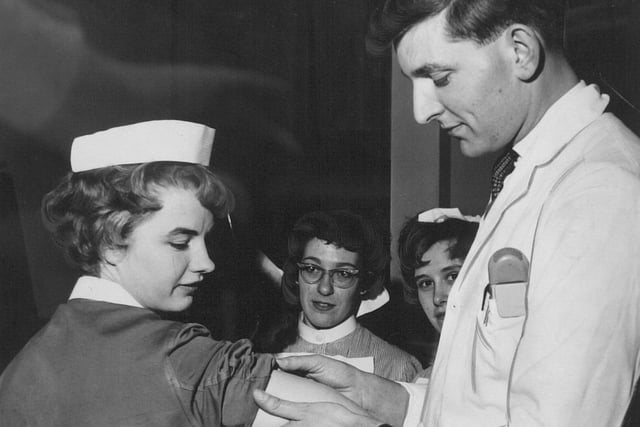 Dr. R. M. Holman vaccinates Sister D. Bradley against smallpox at St. James Hospital. Staff in Leeds hospitals were vaccinated as a precautionary measure.