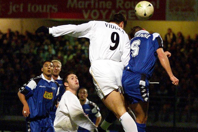 Mark Viduka rises above Gharib Amzine to score during the UEFA Cup second round, second leg match in France.